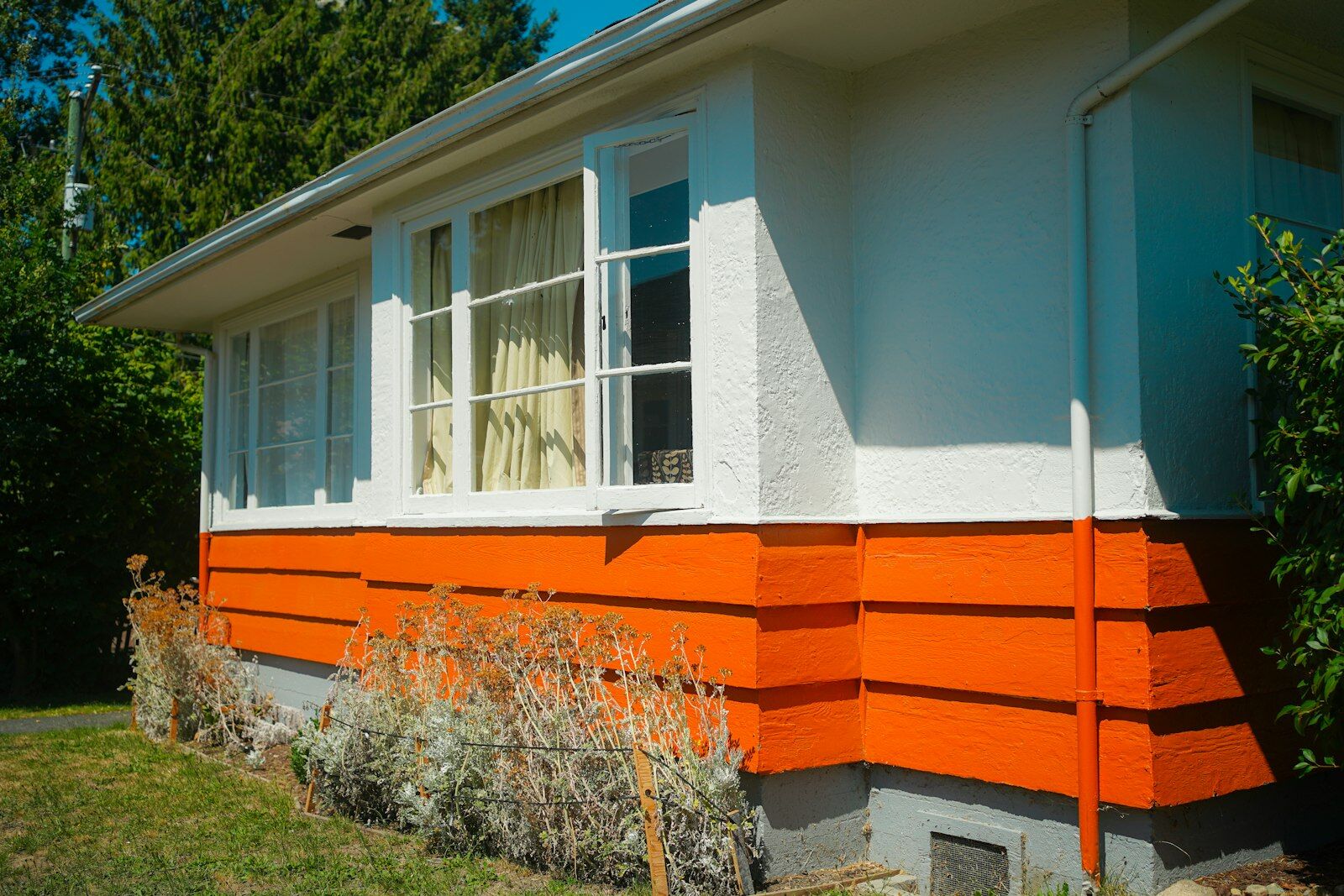 White house exterior with the lower section painted bright orange